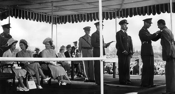 King George VI Presenting awarda at the Military Investiture at Pretoria on the left can