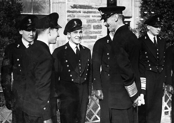 King Haakon of Norway enjoys a joke with Norwegian Naval Cadets at their training college