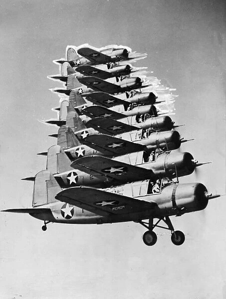 Nine kingfisher scout planes of the United States navy fly in close formation during