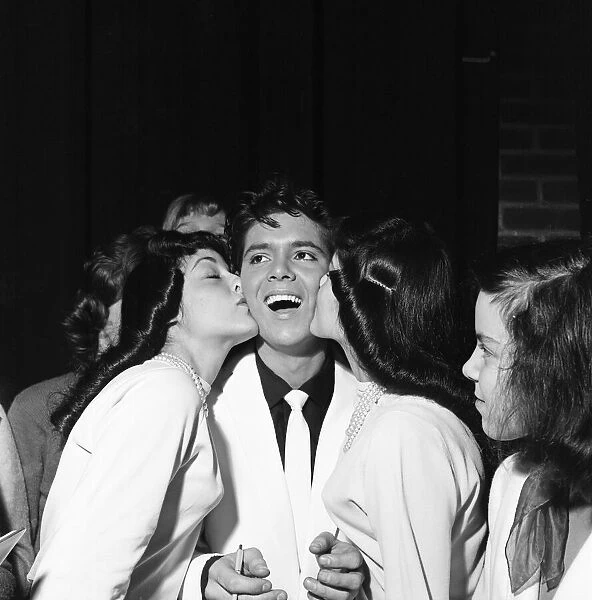 A kiss for Cliff Richard from twin fans at Rochester, New York, USA