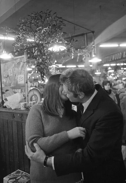 A kiss under the mistletoe for 15-year-old Susan Young from Eric Tweed at Coventry Retail