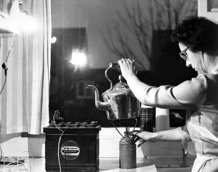Framed Print : In the kitchen a spare car battery and a headlamp bulb give enough light to work in Framed Print : In the kitchen a spare car battery and a headlamp bulb give enough light to work in
