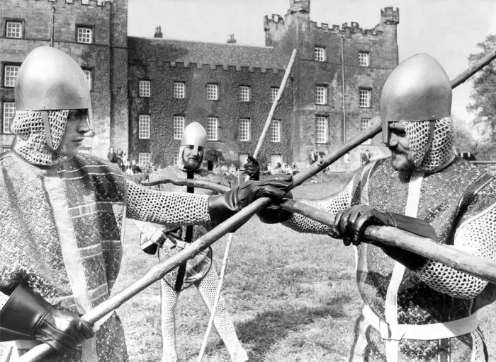 Framed Print : Knaves in jerkins and steel helmets battle with quarter staffs during the jousting Framed Print : Knaves in jerkins and steel helmets battle with quarter staffs during the jousting