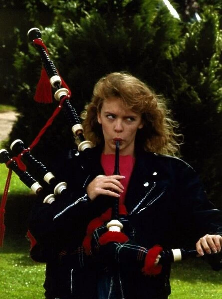 Kylie Minogue blowing into bagpipes September 1988