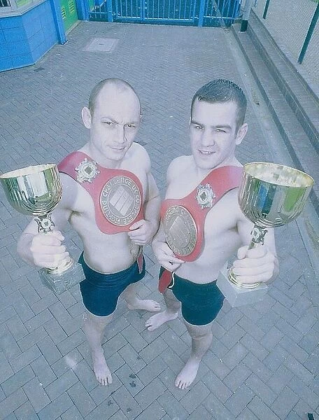 L-R: Matthew Evans and Justin Gray. Two men hold their Vale Tudo tropies