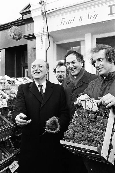 Labour leader Neil Kinnock juggles with produce at a market in Wandsworth, London