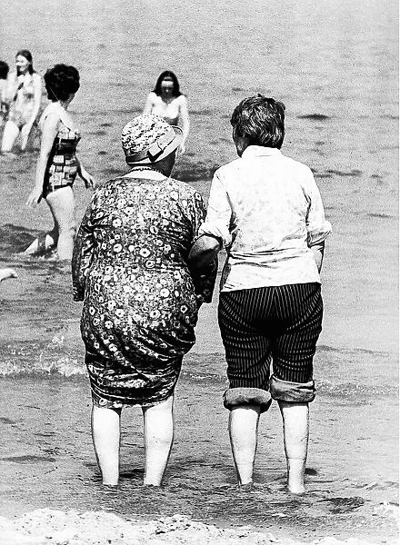 Two ladies plodge in the sea at Tynemouth in june 1976