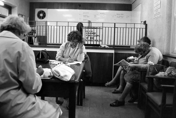 Framed Print : Four ladies studying the form guide before placing their bets at a Ladies only betting Framed Print : Four ladies studying the form guide before placing their bets at a Ladies only betting