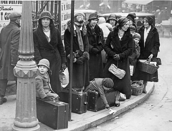 Ladies with their young charges await the bus to take them on their holidays at Easter