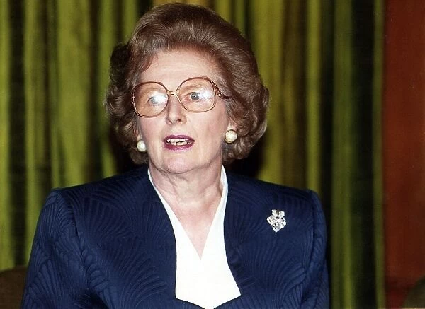 Lady Margaret Thatcher at a press conference wearing glasses