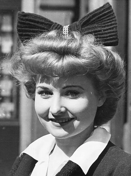 A lady pictured in Bond Street, London, W1. She wears a large bow in her hair