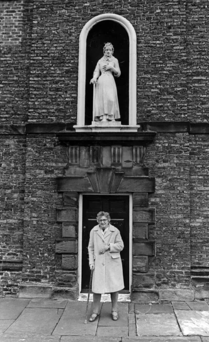 Framed Print : A lady stands outside Sir William Turners Almhouses, Kirkleatham. 14th February 1981 Framed Print : A lady stands outside Sir William Turners Almhouses, Kirkleatham. 14th February 1981