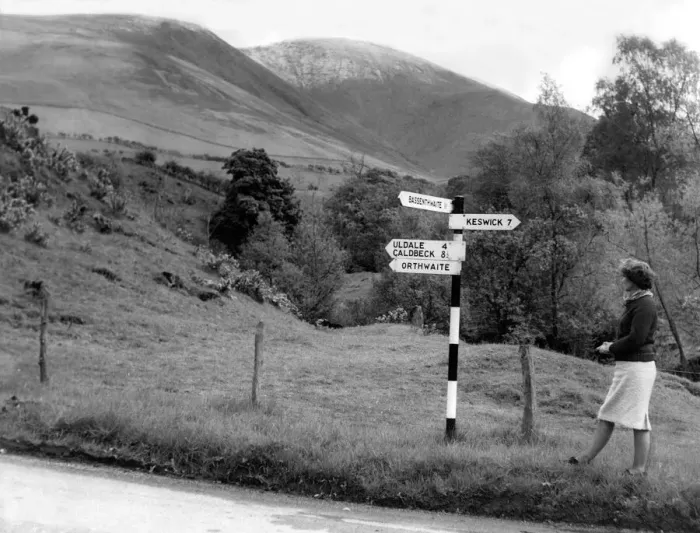 Framed Print : Lake District - A sign post points a woman in the right direction near Orthwaite 1 May Framed Print : Lake District - A sign post points a woman in the right direction near Orthwaite 1 May