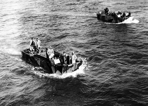 Two landing craft carrying British paratroopers return after a night raid on a German