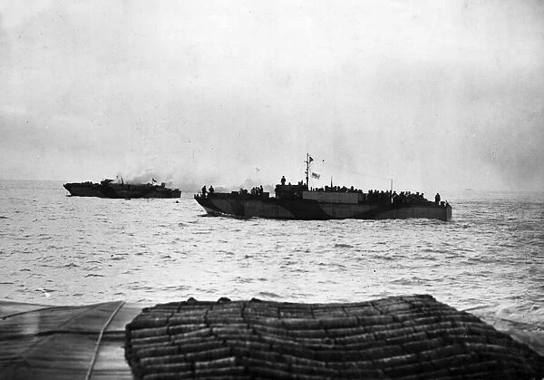 A landing craft infantry going to the aid of LCI (S) 532 which was hit by enemy shells