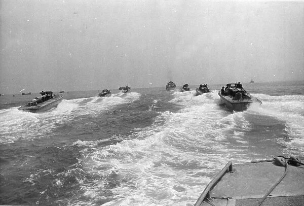 The Landing Craft Personnel or LCP speed towards their rendezvous