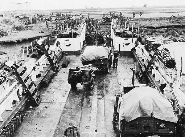 A landing craft being unloaded at the Rangoon beach head. 17th May 1945