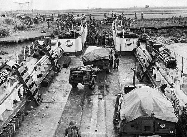 Landing craft being unloaded at the Rangoon (Yangdon) beach head. May 1945