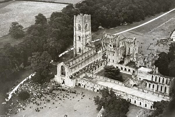 A large congregation gathers at Fountains Abbey near Ripon for an open air Sunday service