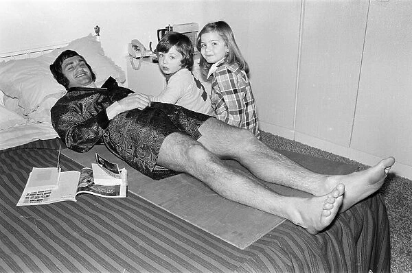 Larry Lloyd Coventry City football player lying on bed at home as he recuperates