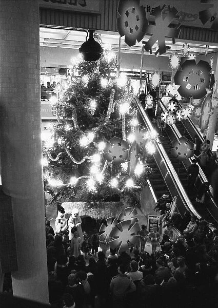Late night shoppers admiring the giant Christmas tree and display following Reading