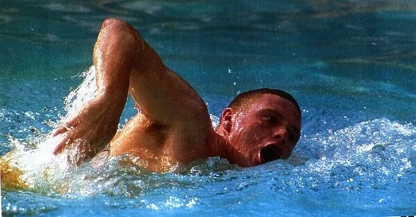 Lazio and England footballer Paul Gascoigne swimming in a pool in Rome as he battles to