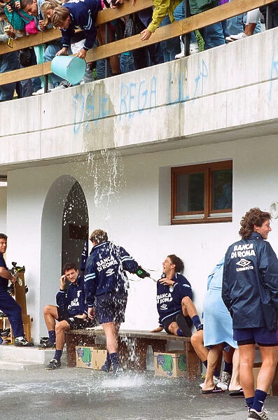 Lazio footballer Paul Gascoigne has a bucket of water tipped over him by teammate Beppe