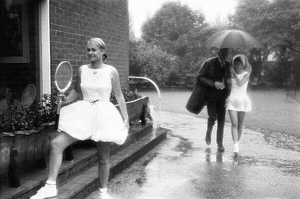Lea Pericoli v Susanna Alexander at the rain soaked pre Wimbledon garden party at