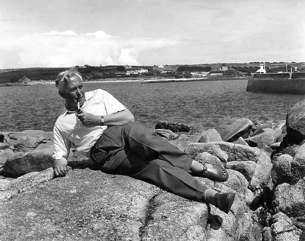 Leader of the Labour Party Harold Wilson, relaxes on the rocks at St