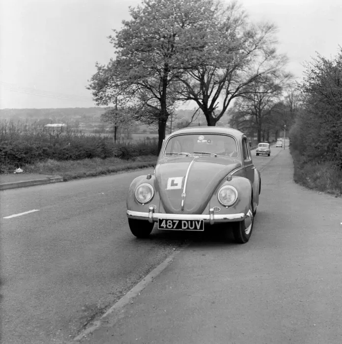 Framed Print : Learner driver in a Volkswagen Beetle. May 1962 Framed Print : Learner driver in a Volkswagen Beetle. May 1962