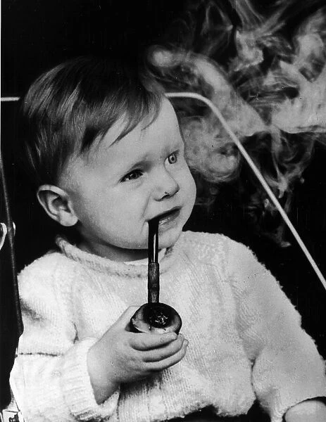Lee Goult (17 months) smokes his cherrywood pipe, his father Allan Goult says he was