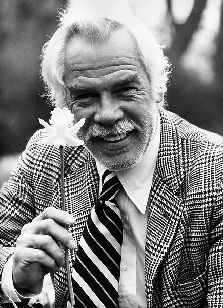 Lee Marvin American actor holding daffodil 1975