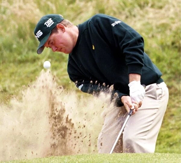 Lee Westwood hits out of a bunker on the second hole during the third round of the Open