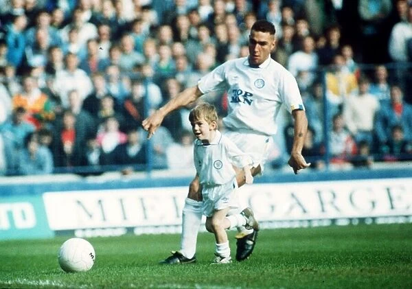 Leeds United footballer Vinnie Jones tackling the match mascot. 23rd October 1989
