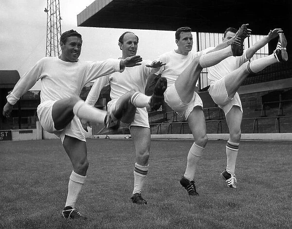 Leeds United players Bobby Collins, Mason, Lawson, and Storrie high kicking during