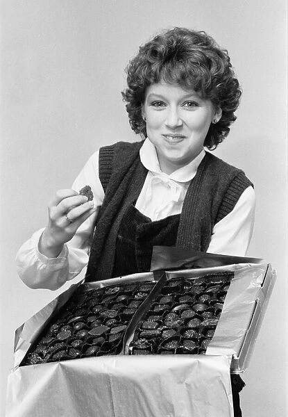Lena Zavaroni, aged 16, eating from box of chocolates, January 1980