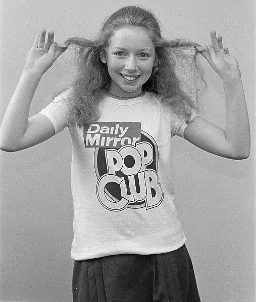 Lena Zavaroni wears a Daily Mirror Pop Club T-Shirt. 5th May 1976