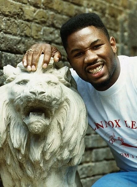 Lennox Lewis Boxer with his hand on a statue of a Lion