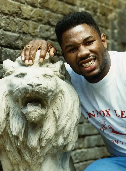 Framed Print : Lennox Lewis Boxer with his hand on a statue of a Lion
