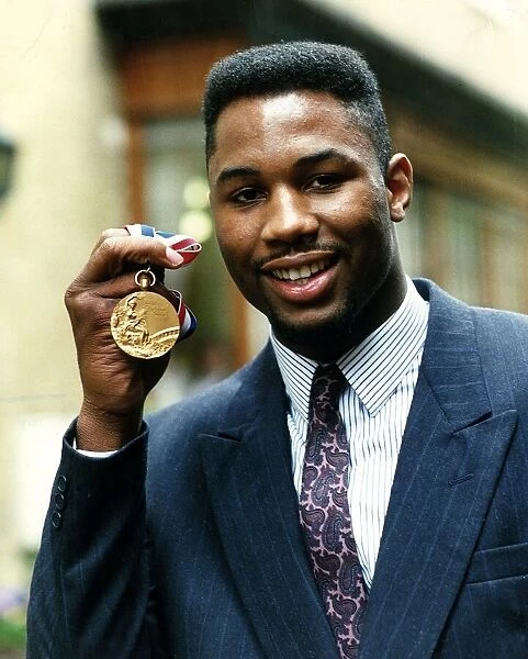 Lennox Lewis boxer holding gold medal April 1989