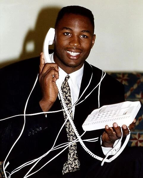 Lennox Lewis Boxing Heavyweight Boxer tied up with telepohone cord while talking