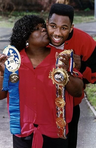 Lennox Lewis WBC World Heavyweight Boxing Champion being kissed on the cheek by his