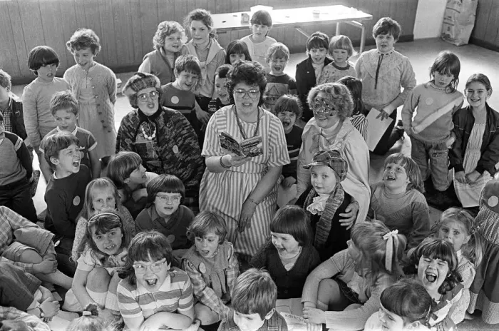 Framed Print : These Lepton Children enjoy a Super Hero'story read to them by library