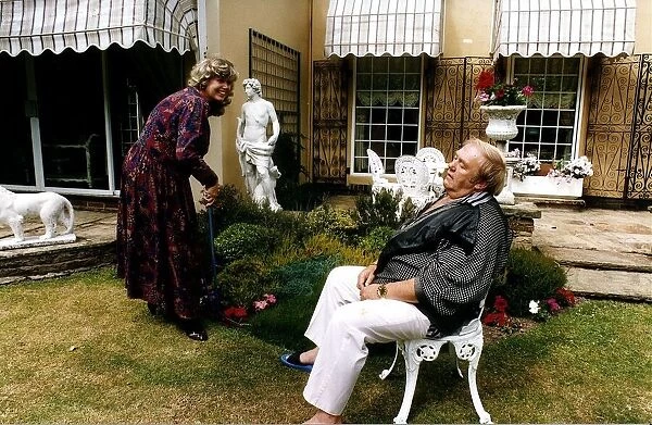 Les Dawson Comedian with wife in garden pretending he is exhausted
