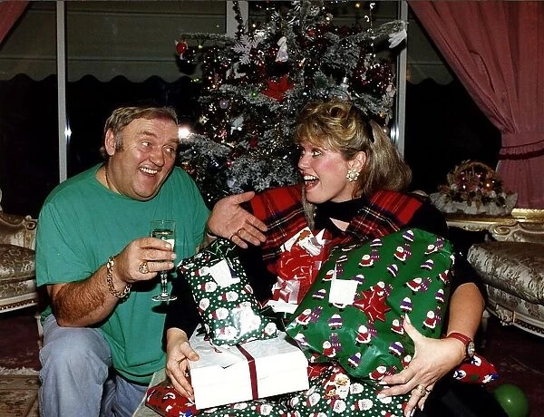 Les Dawson comedian with his wife Tracey with christmas presents