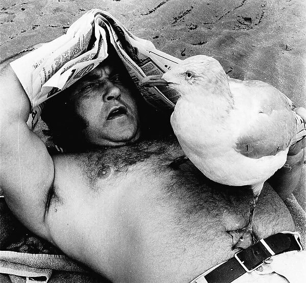 Les Dawson Lying on Bridlington Beach with a stuffed seagull on his chest dbase msi