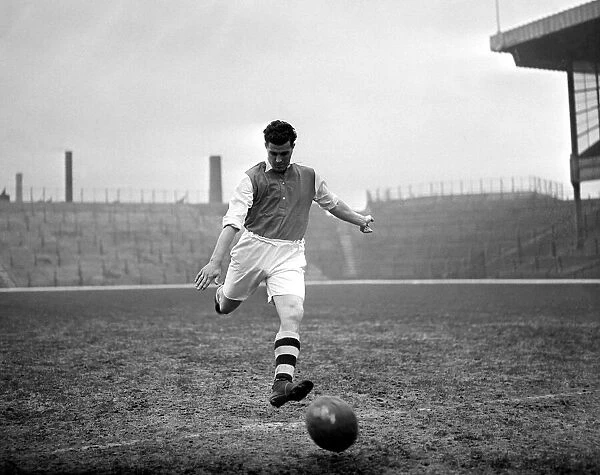 Leslie Compton kicks a football at Highbury Arsenal footballer circa 1935