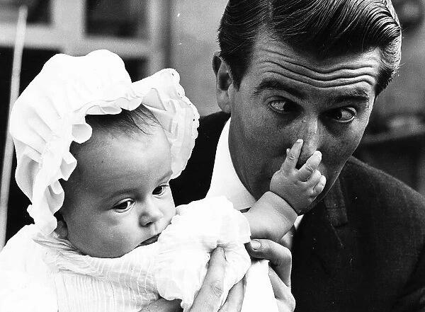 Leslie Crowther TV presenter with baby Charlotte Crowther at her christening in 1963