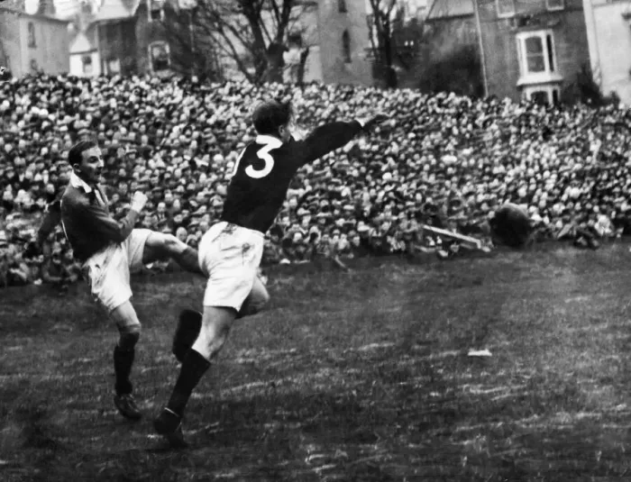 Framed Print : Lewis Jones attempting attempts to clear off the Welsh as his kick is charged down by C. W