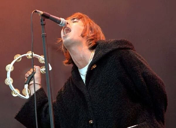 Liam Gallagher singing into microphone during the Oasis concert at Balloch Country Park